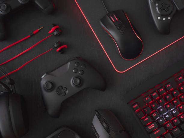 istock gamer workspace concept, top view a gaming gear, mouse, keyboard, joystick, headset, mobile joystick, in ear headphone and mouse pad on black table background. 1051243610