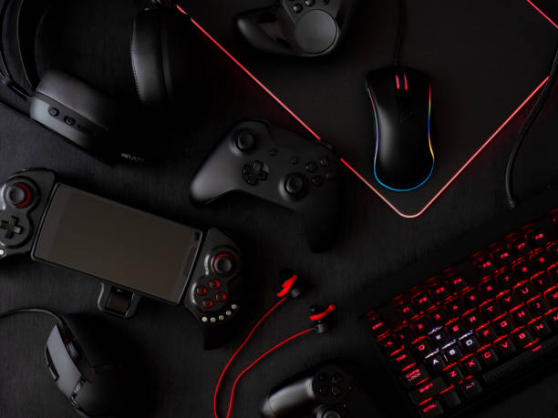istock gamer workspace concept, top view a gaming gear, mouse, keyboard, joystick, headset, mobile joystick, in ear headphone and mouse pad on black table background. 1051243618