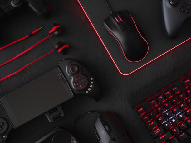 istock gamer workspace concept, top view a gaming gear, mouse, keyboard, joystick, headset, mobile joystick, in ear headphone and mouse pad on black table background. 1051243638