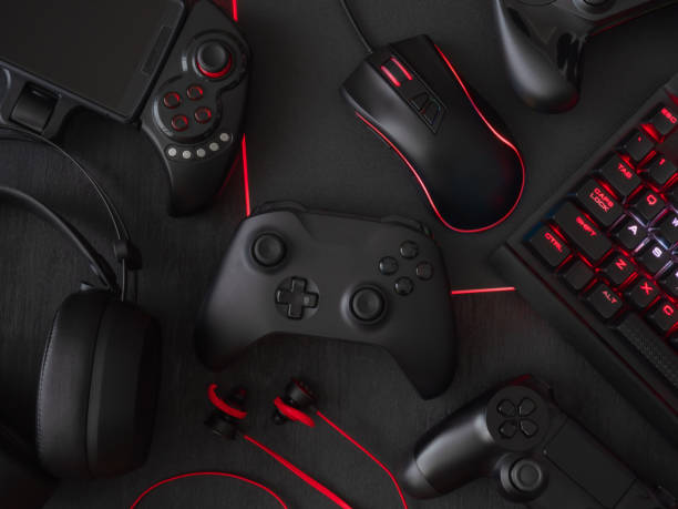 istock gamer workspace concept, top view a gaming gear, mouse, keyboard, joystick, headset, mobile joystick, in ear headphone and mouse pad on black table background. 1051243646
