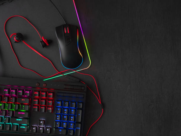 istock gamer workspace concept, top view a gaming gear, mouse, keyboard, joystick, headset, mobile joystick, in ear headphone and mouse pad on black table background. 1051243676