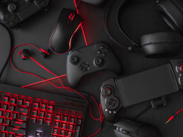 istock gamer workspace concept, top view a gaming gear, mouse, keyboard, joystick, headset, mobile joystick, in ear headphone and mouse pad on black table background. 1051243692