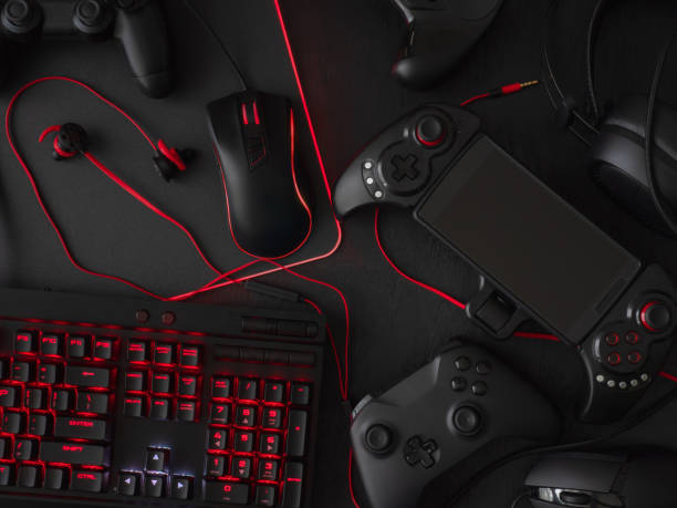 istock gamer workspace concept, top view a gaming gear, mouse, keyboard, joystick, headset, mobile joystick, in ear headphone and mouse pad on black table background. 1051243696
