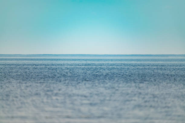 Turquoise ocean surface with clear sky. Minimalism photo.