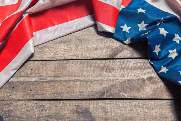 istock An American Flag Lying on an aged, weathered rustic wooden background 1051244600