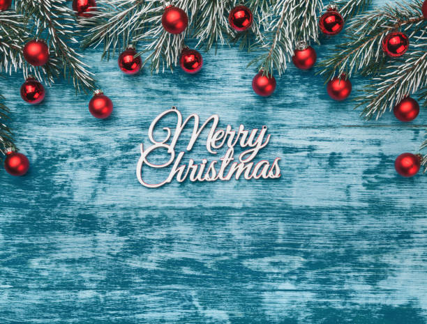 istock Christmas azure christmas background, fir branches with red globes 1051244726