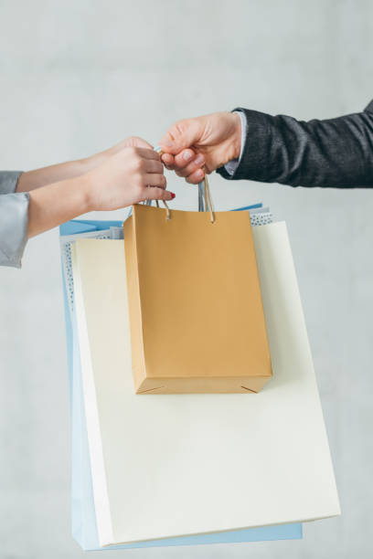 istock store delivery shopping man pass bags customer 1051247354