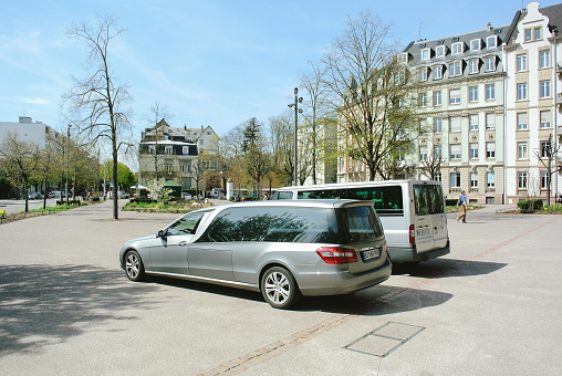 PARIS, FRANCE - APR 17, 2013: Mercedes-Benz hearse used to carry the dead persons in a coffin or casket parked in front of the church