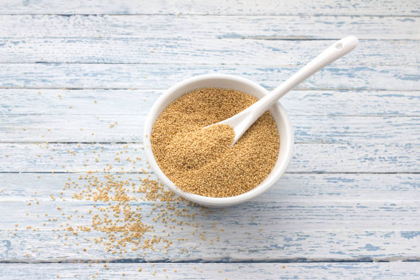 istock Raw amaranth seeds in a ceramic bowl on a light blue background 1051248184