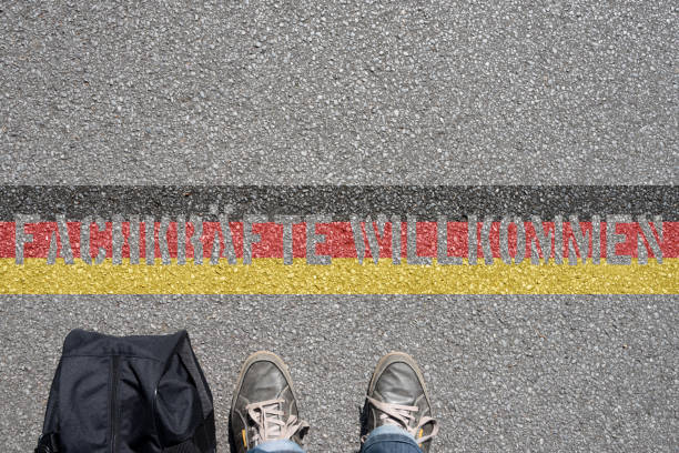 istock A man with a suitcase, German flag and slogan specialists welcome 1051248832