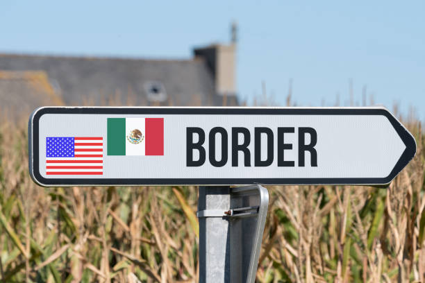 A sign indicates the U.S.-Mexico border stock photo