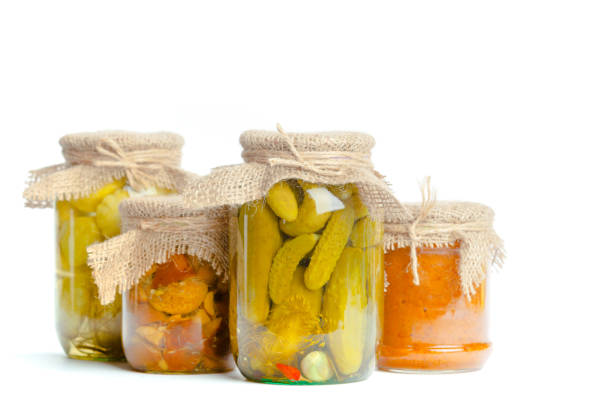 istock Canned vegetables in glass jars isolated on white background 1051267956