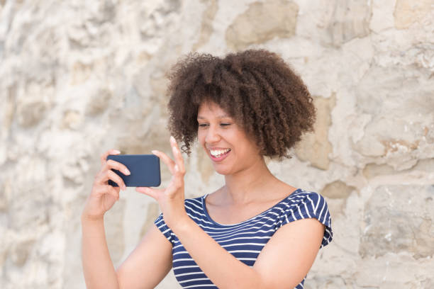 istock Attractive Young Woman Taking Pictures 1051272500
