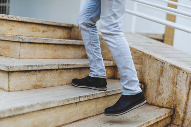 istock Low Section Of Man Walking On Staircase 1051276994