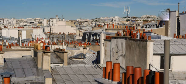 istock The roofs of Paris and its chimneys under a clouds sky 1051278776