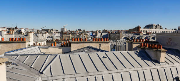 istock The roofs of Paris and its chimneys under a clouds sky 1051279076