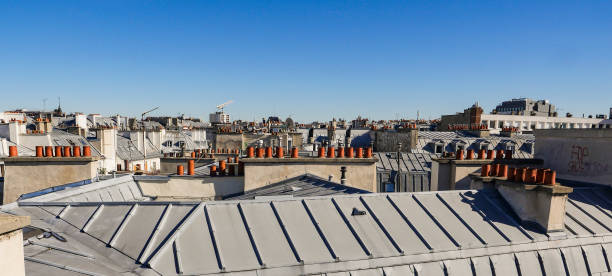 istock The roofs of Paris and its chimneys under a clouds sky 1051279276