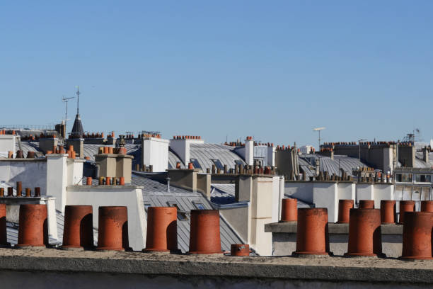 istock The roofs of Paris and its chimneys under a clouds sky 1051281530
