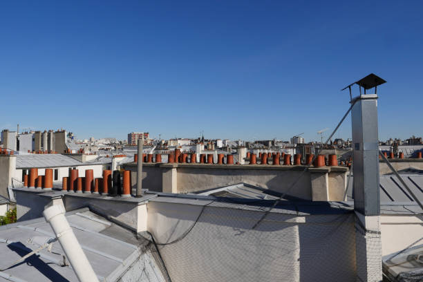 istock The roofs of Paris and its chimneys under a clouds sky 1051281768