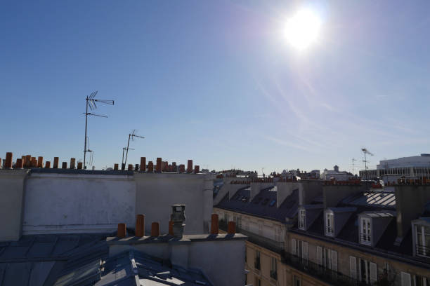 istock The roofs of Paris and its chimneys under a clouds sky 1051282096