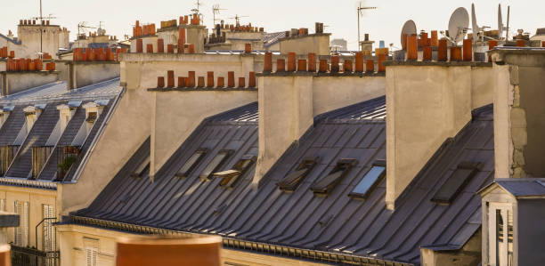 istock The roofs of Paris and its chimneys under a clouds sky 1051282210