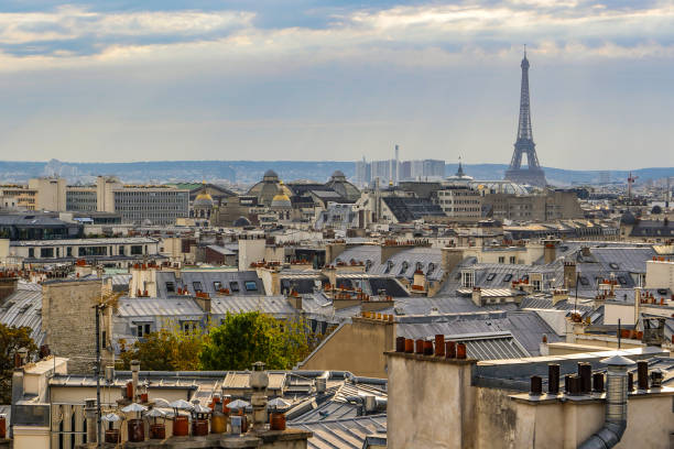 istock The roofs of Paris and its chimneys under a clouds sky 1051282442