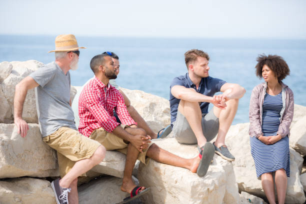 istock Five Friends Talking By The Sea 1051282756