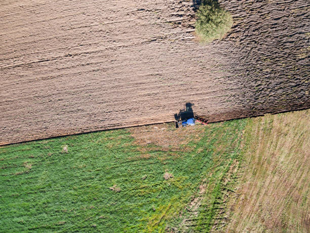 istock Aerial view of tractor plowing the field 1051283372