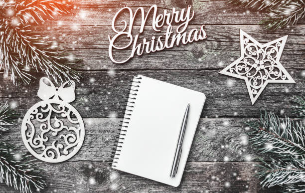 istock Winter composition, on old wood background. The space list for a Christmas message. Snow effect and light blips 1051283644