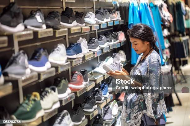 Woman Choosing Sport Shoes Stock Photo - Download Image Now - Sports Shoe, Shopping, Retail