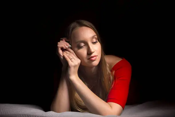 Portrait of a beautiful blonde girl with long hair. Emotions thinking and calm mood. Pretty woman.