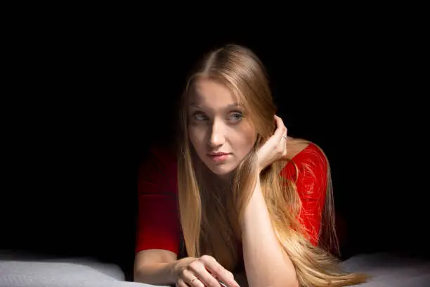 Portrait of a beautiful blonde girl with long hair. Emotions thinking and calm mood. Pretty woman.