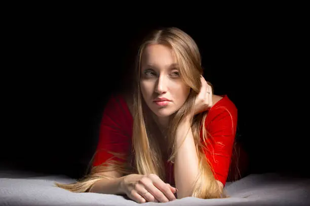 Portrait of a beautiful blonde girl with long hair. Emotions thinking and calm mood. Pretty woman.