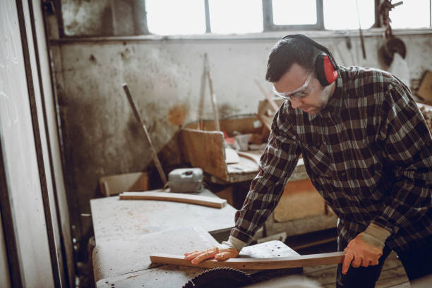 istock Male Carpenter Sawing Through Chair Handle 1051286718