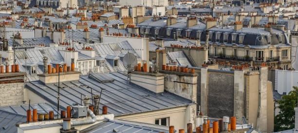 istock The roofs of Paris and its chimneys under a clouds sky 1051287644