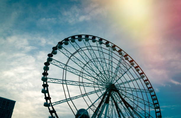 istock Low Angle View Of Ferris Wheel Against Cloudy Sky During Sunset 1051288988