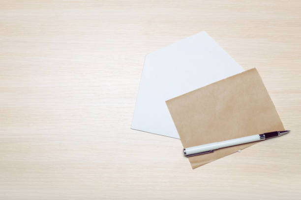 istock Photo of blank envelope on a  wooden background 1051290888