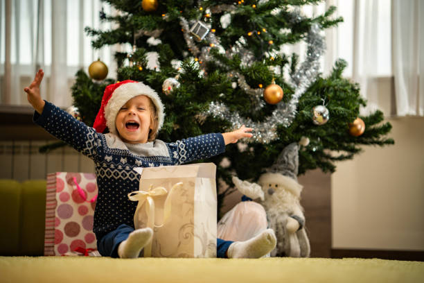 istock Little cute boy is looking forward to a Christmas present 1051293126