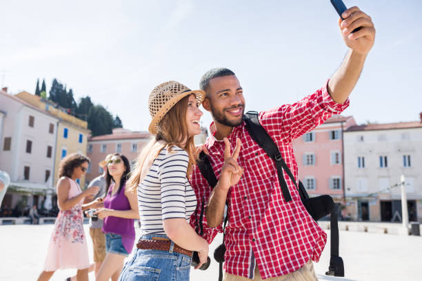 istock Smiling Men And Women Taking Selfie 1051299280
