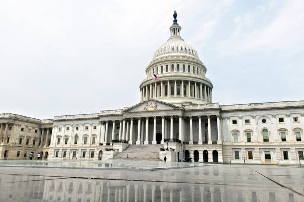 istock Low Angle View Of Government Building Against Cloudy Sky 1051299744