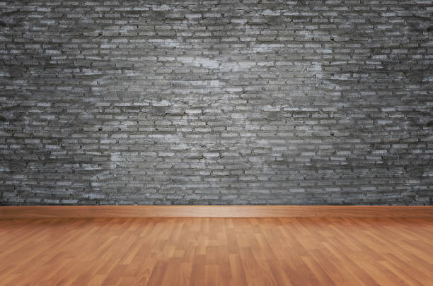 istock Hardwood Floor By Brick Wall 1051302540