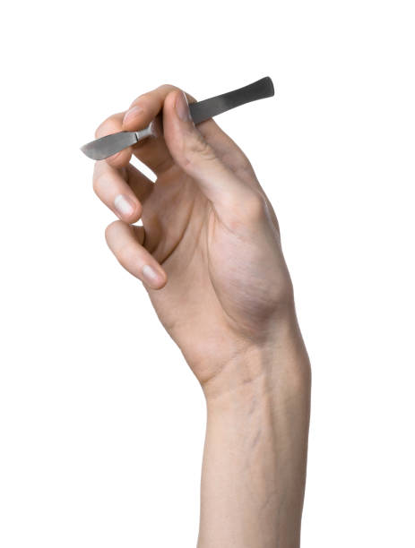 istock The hand holding the scalpel, white background, isolated 1051303794