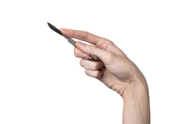istock The hand holding the scalpel, white background, isolated 1051303884