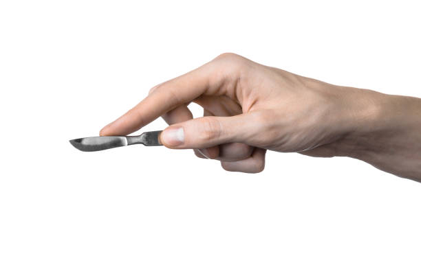istock The hand holding the scalpel, white background, isolated 1051303952