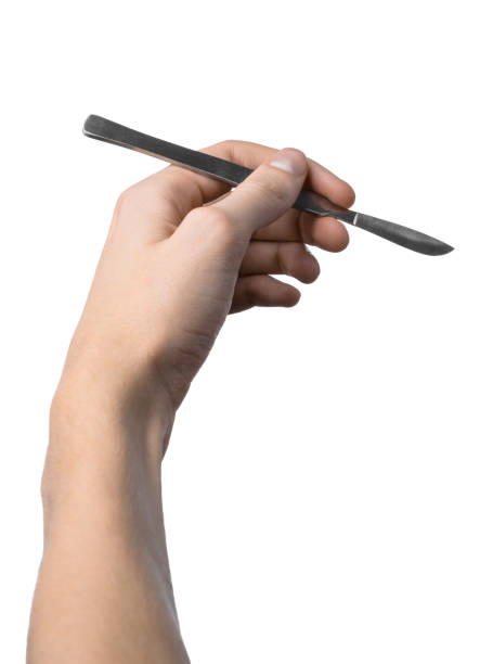 istock The hand holding the scalpel, white background, isolated 1051304336
