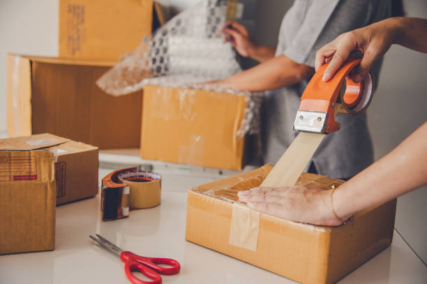 istock Team staff packed in brown boxes to deliver to customers 1051307780