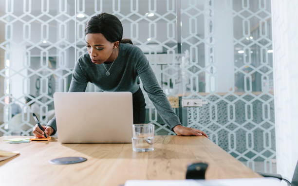 istock Businesswoman in boardroom making notes for meeting 1051311726