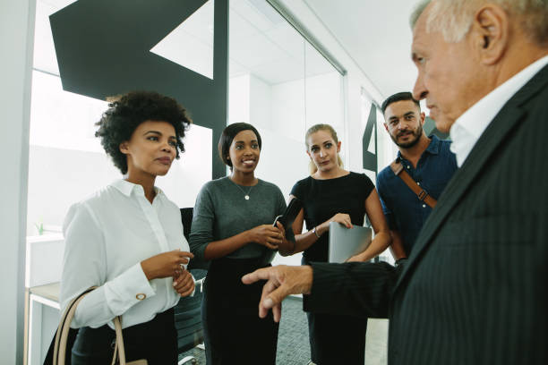 istock Business group talking in office corridor 1051312354