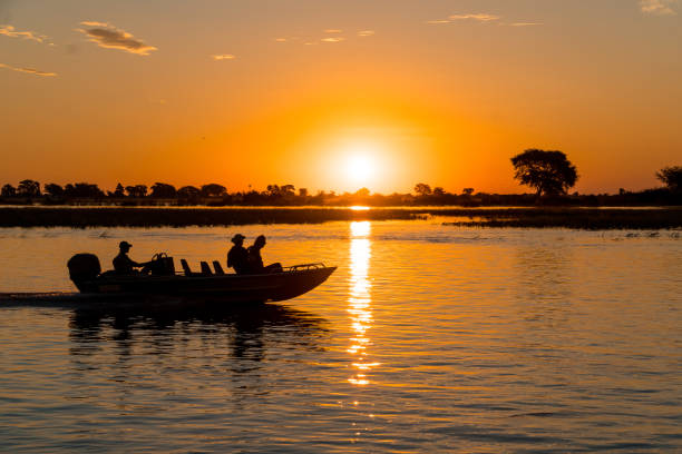 istock Silhouette Of People On Boat Watching Sunset 1051312872