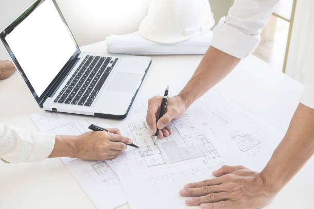 istock Cropped Image Of Architects Working On Blueprint 1051313550